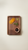 Contemporary Walnut Charcuterie Board, 3/4 angle is default — board sits slightly turned on a neutral Sunlit Birch surface...